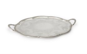 A Victorian silver shaped oval twin handled tray by Thomas Bradbury & Sons