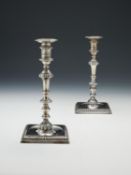 A pair of George III cast silver square candlesticks