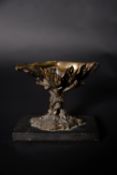 A patinated bronze table salt in the form of a clam shell