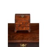 A walnut and line inlaid miniature bureau