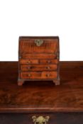 A walnut and line inlaid miniature bureau