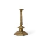 An impressive English repoussé brass columnar candlestick