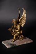 An Empire gilt bronze model of an amorino on a unicycle