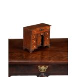 A walnut and line inlaid miniature kneehole desk