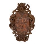 A Queen Anne carved pine armorial