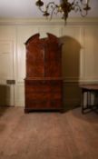 A George I walnut and featherbanded secretaire cabinet