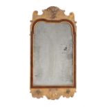 A George I gilt gesso, walnut and parcel gilt wall mirror