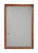 A George I walnut and parcel gilt wall mirror