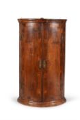 A George I walnut hanging corner cupboard