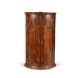 A George I walnut hanging corner cupboard