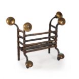 A Charles II wrought iron and brass fire grate