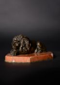 An Italian patinated bronze Grand Tour souvenir model of a recumbent lion after Antonio Canova