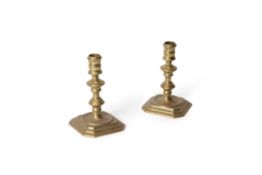 A pair of Queen Anne brass candlesticks