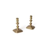 A pair of Queen Anne brass candlesticks