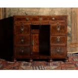 A William & Mary walnut and feather banded kneehole desk