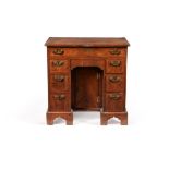 A George I walnut and feather banded kneehole desk