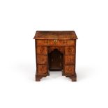 A Queen Anne walnut and crossbanded kneehole desk