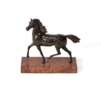 A French or Italian patinated bronze model of a prancing horse