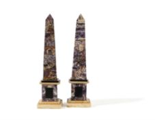 A pair of amethyst quartz veneered and marble mounted obelisks