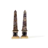 A pair of amethyst quartz veneered and marble mounted obelisks