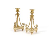 A pair of Napoleon III gilt bronze and onyx mounted candlesticks