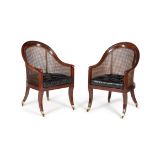 A pair of Regency mahogany library bergere or 'curricle' armchairs