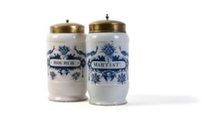 Two Dutch Delft blue and white cylindrical drug jars and gilt-metal covers