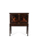 A black lacquer and gilt chinoiserie decorated cabinet on stand