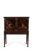 A black lacquer and gilt chinoiserie decorated cabinet on stand