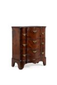 A walnut and feather banded serpentine fronted chest of drawers