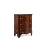 A walnut and feather banded serpentine fronted chest of drawers