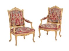 A pair of carved giltwood open armchairs