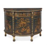 A dark green painted and gilt chinoiserie decorated demi-lune commode