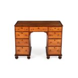 An early Victorian birch and yew kneehole desk