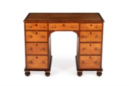 An early Victorian birch and yew kneehole desk