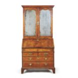 A George I walnut and feather banded bureau bookcase