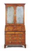 A George I walnut and feather banded bureau bookcase