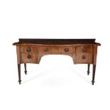 A George III mahogany and crossbanded serpentine sideboard