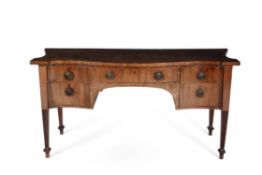 A George III mahogany and crossbanded serpentine sideboard