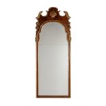 A walnut and parcel gilt wall mirror