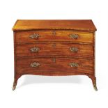 A George III mahogany concave fronted chest of drawers