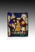 A stained glass panel with a King on horseback