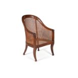 A Regency mahogany and caned library bergere armchair