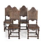 A set of four Iberian exotic hardwood and embossed leather upholstered chairs