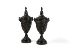 A pair of fine French patinated bronze urns and covers