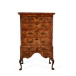 A George I walnut and feather banded chest on stand