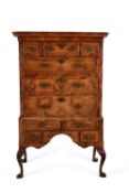 A George I walnut and feather banded chest on stand