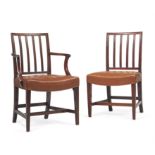 A set of fourteen George III mahogany and leather upholstered dining chairs
