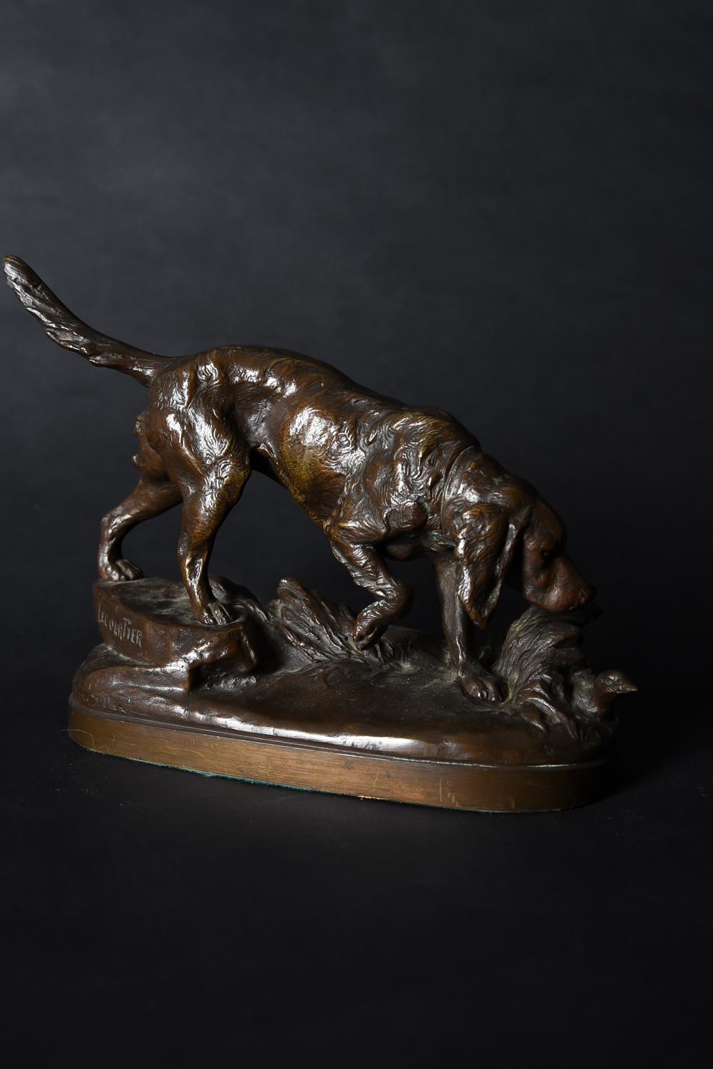 Prosper Lecourtier (French, 1855-1924), a patinated bronze model of a spaniel chasing a bird