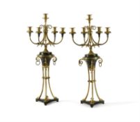 A pair of gilt and patinated bronze five light candelabra in late Louis XVI taste